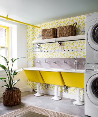 laundry room with yellow sinks and yellow wallpaper