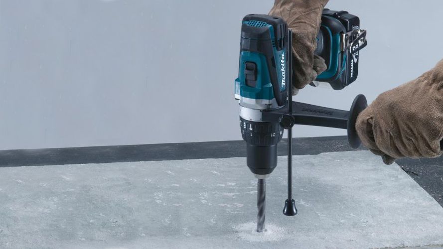 a Makita DHP458Z 18V Cordless Hammer Drill drilling into concrete