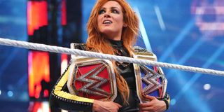 "The Man" Becky Lynch holding her titles