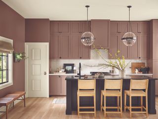 Dusty dark pink painted kitchen cabinets and hanging pendent lights