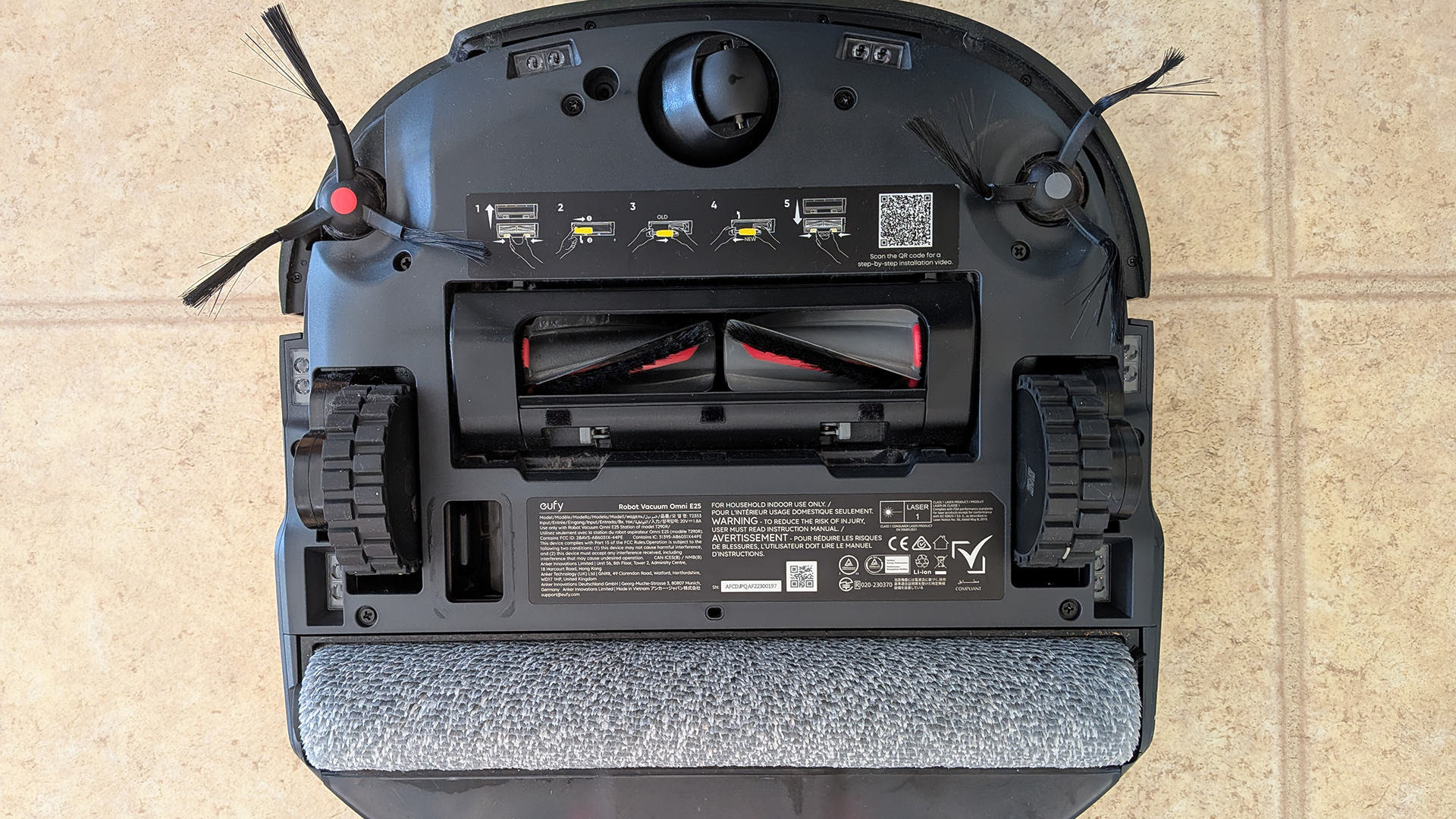 Eufy E25 Omni robot vacuum flipped over to show underside