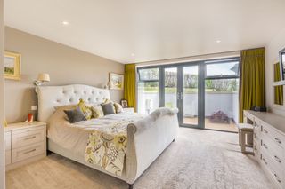 A bedroom inside the eco property with glass doors leading outside