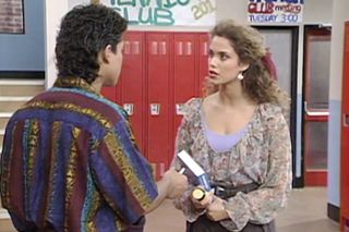 mario lopez and Elizabeth Berkley have a conversation in the school hallway in 'Saved by the Bell'