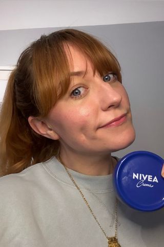 a headshot of matilda holding a tub of nivea creme