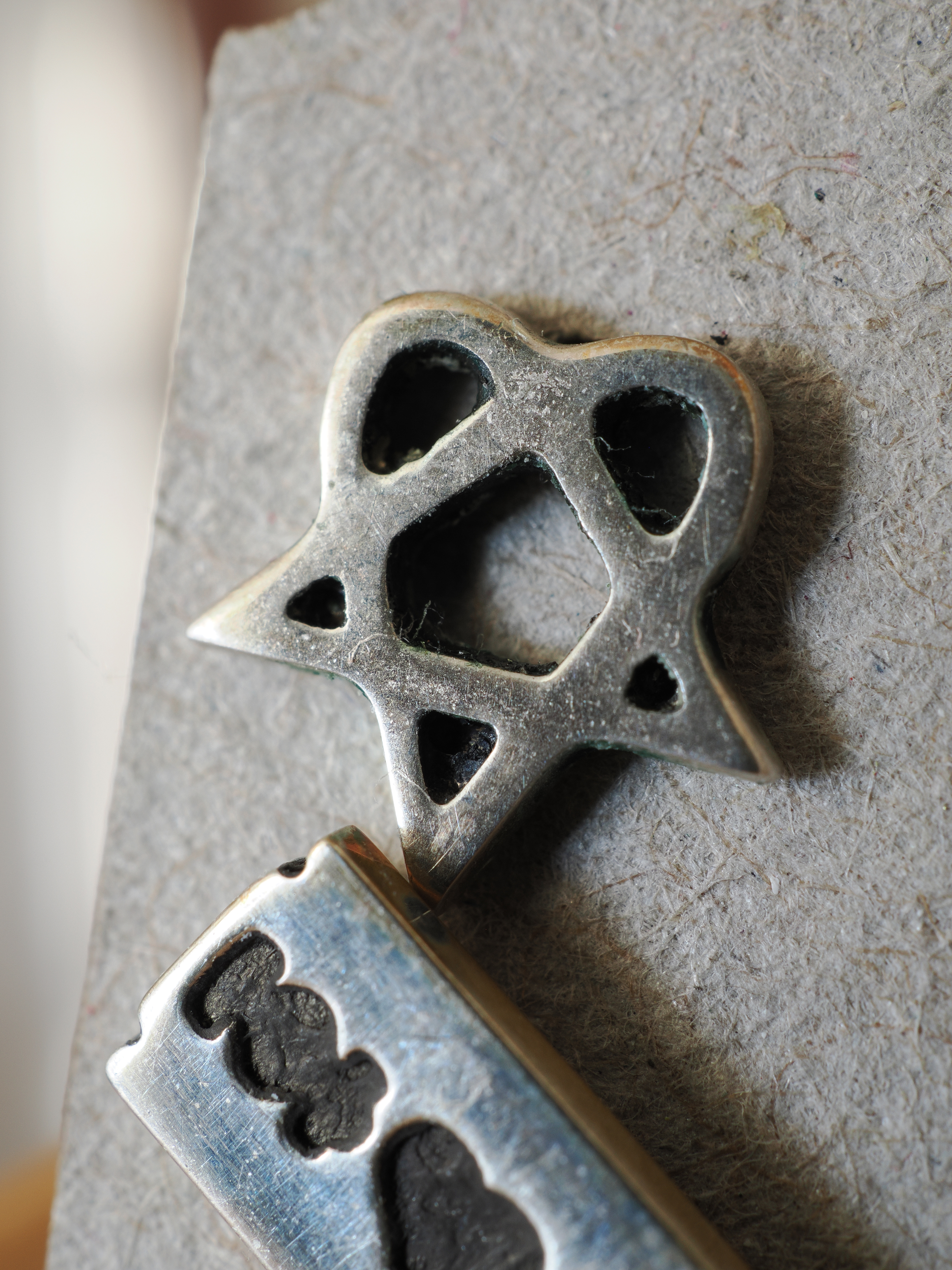 Macro image of a Heartagram earring taken on the OM System OM-3 with the Olympus M.Zuiko 30mm f/3.5 Macro