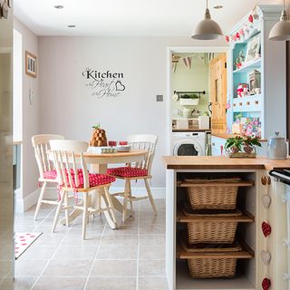 kitchen with cream wall rounded table and chair
