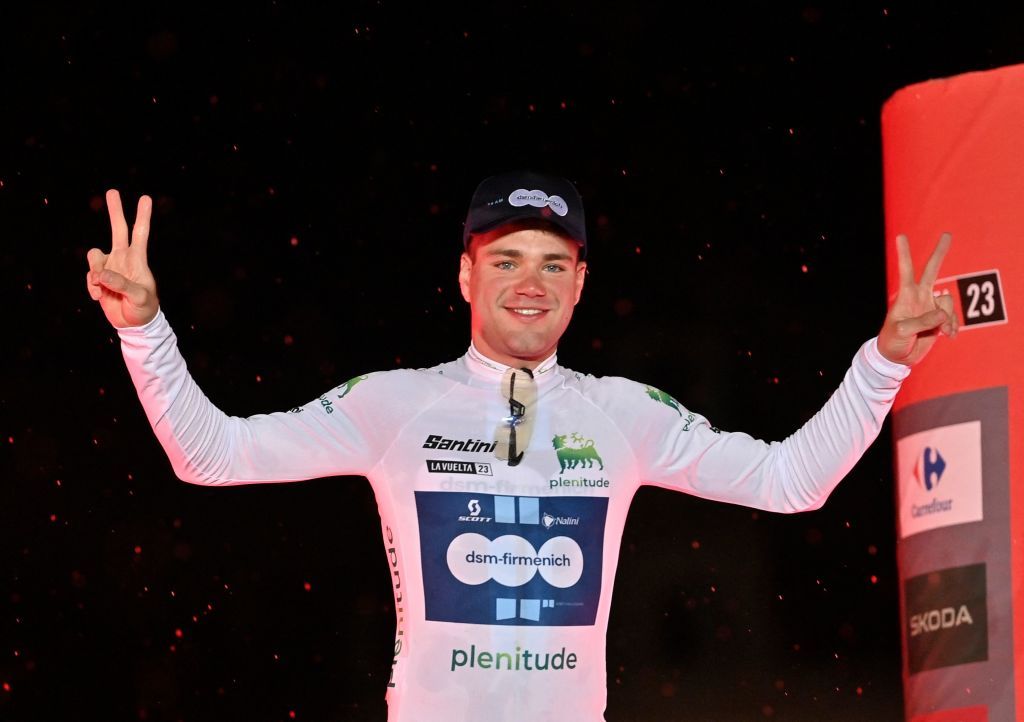 Team Dsms Italian rider Lorenzo Milesi wearing the Youth jersey celebrates on the podium after the first stage of the 2023 La Vuelta cycling tour of Spain a 148 km team timetrial in Barcelona on August 26 2023 Photo by Pau BARRENA AFP Photo by PAU BARRENAAFP via Getty Images