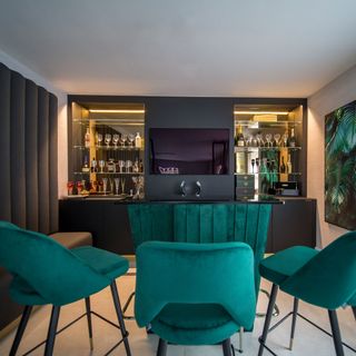 bar area with black table and turquoise chairs