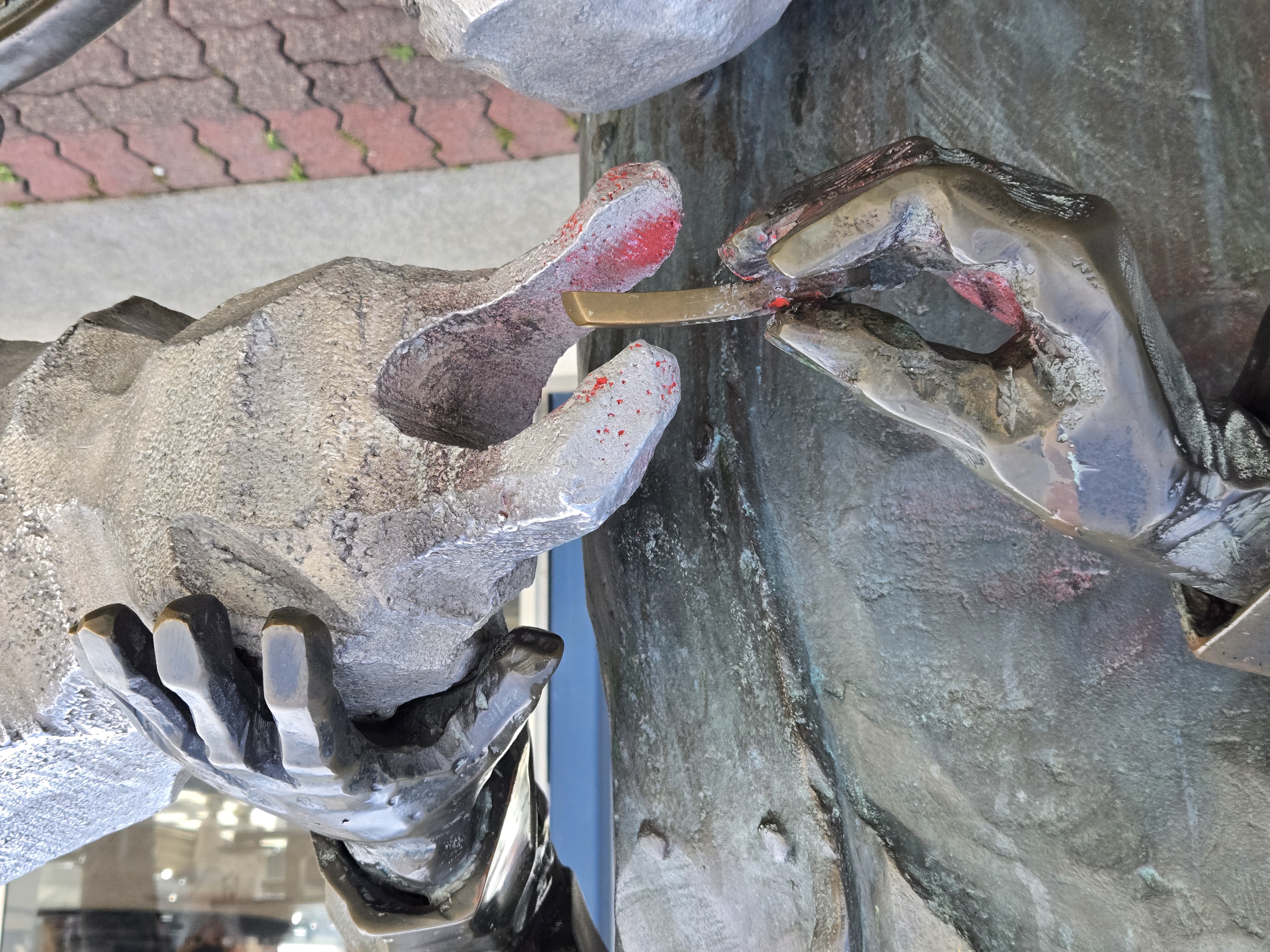 A statue of a man feeding a seagull