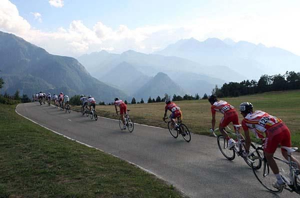 Some riders, with the mountains in the background, on stage three.