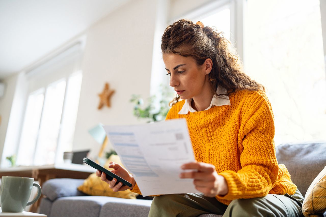 Woman reading a bill and managing her personal finances