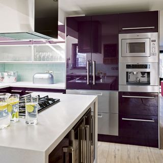 kitchen area with purple kitchen unit and white countertop