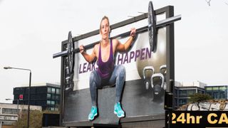 Elvie billboard showing weightlifting woman appearing to pee