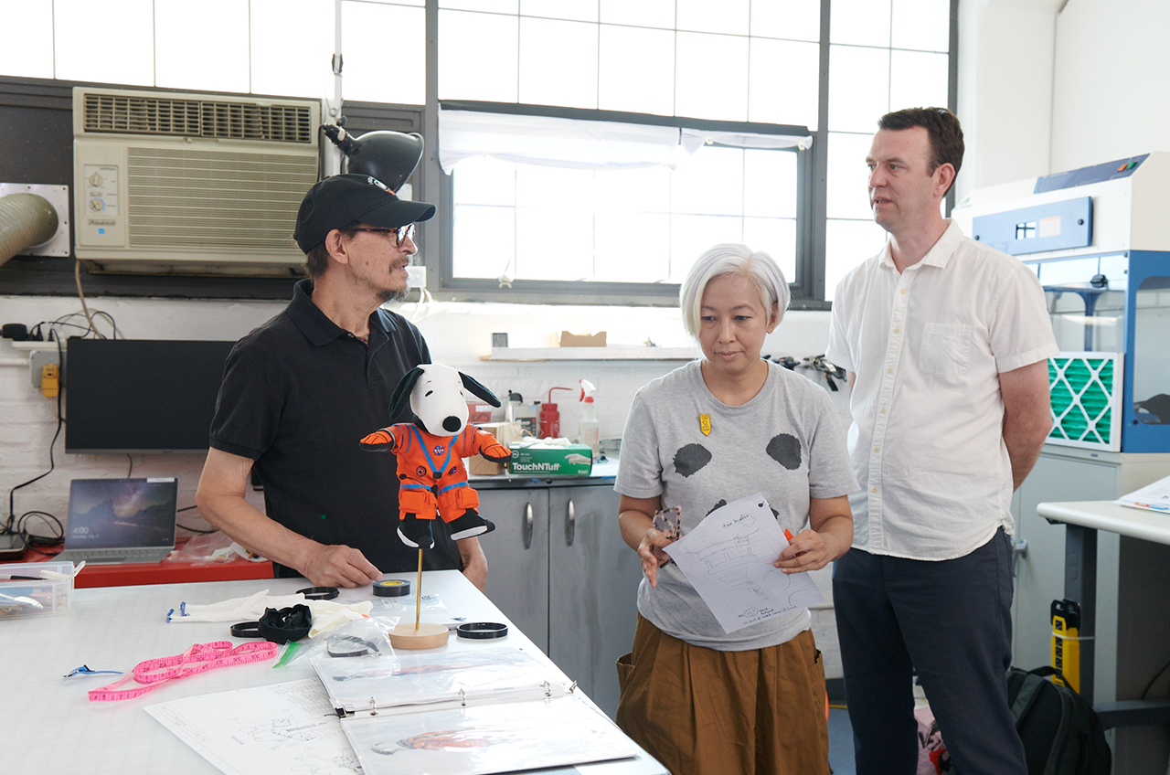 Designers Martin Izquierdo, Shima Ushiba and Ted Southern with the Artemis I zero-gravity indicator (ZGI), astronaut Snoopy.