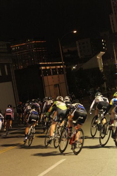 The women's peloton in action under the lights in St. Louis during the Midtown Grand Prix