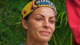 Stephenie looks at the letters from home during the Survivor 50 auction. 