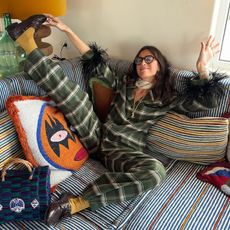 woman in pajamas on a colorful sofa