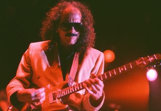 Carlos Santana performs live onstage in 1989