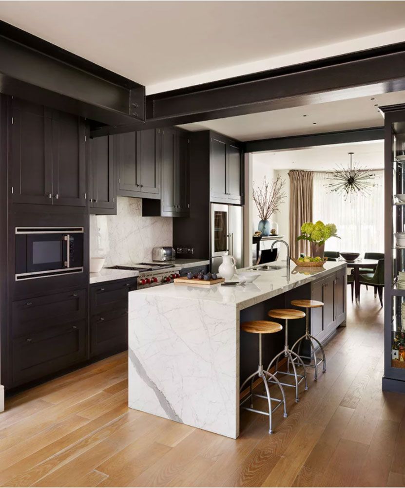 Real wood kitchen flooring ideas with black cabinetry and a marble island.