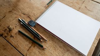 Best sketchbooks - sketchbook on table alongside pencils