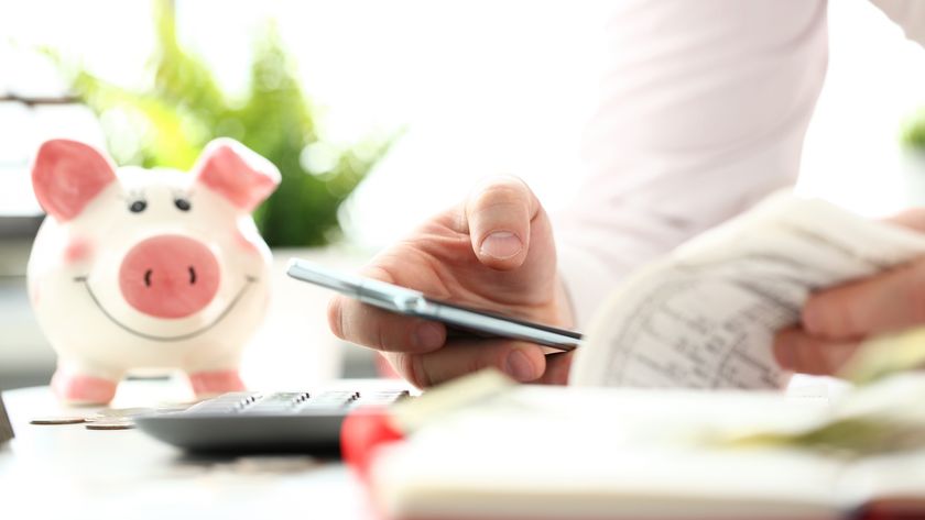 Person holding a smartphone while doing their finances