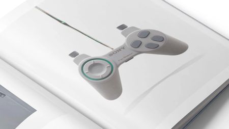 A photo shows a page in the upcoming photography book PlayStation: The First 30 Years that shows a green and grey controller