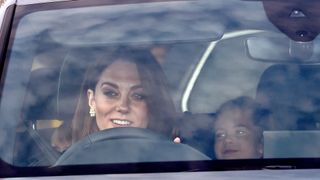 Kate Middleton driving a car with Princess Charlotte in the back seat