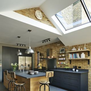 kitchen extension with exposed brick walls and pitched ceiling