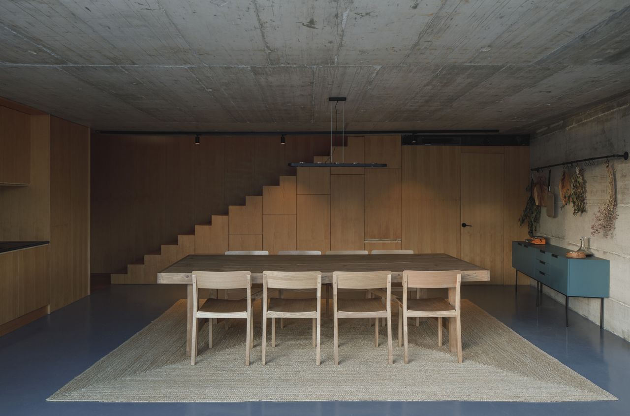 The middle level includes the kitchen and dining area, opening out onto the pool terrace