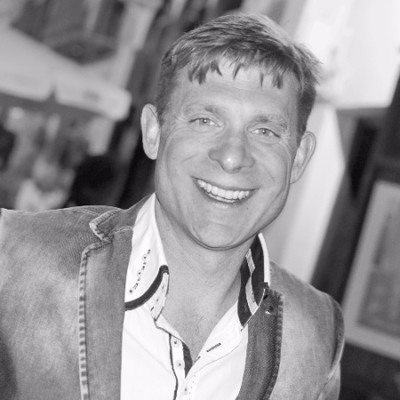 A black and white image o a man in a suit jacket