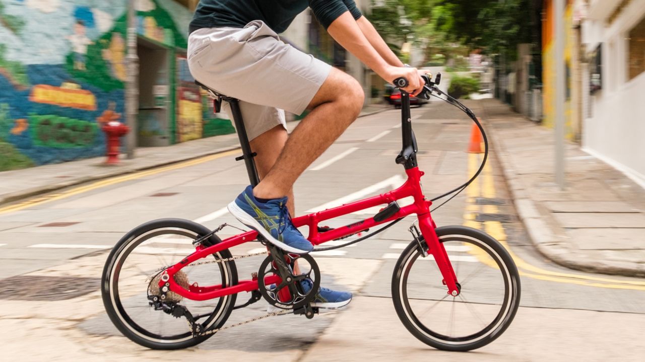 The Tern BYB P10 in red colour being ridden by a white male on a road 