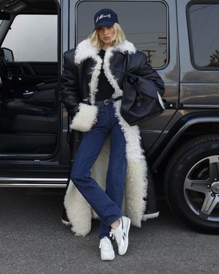 Elsa Hosk wearing a pair Reebok sneakers that tap into the '70s sneaker trend.