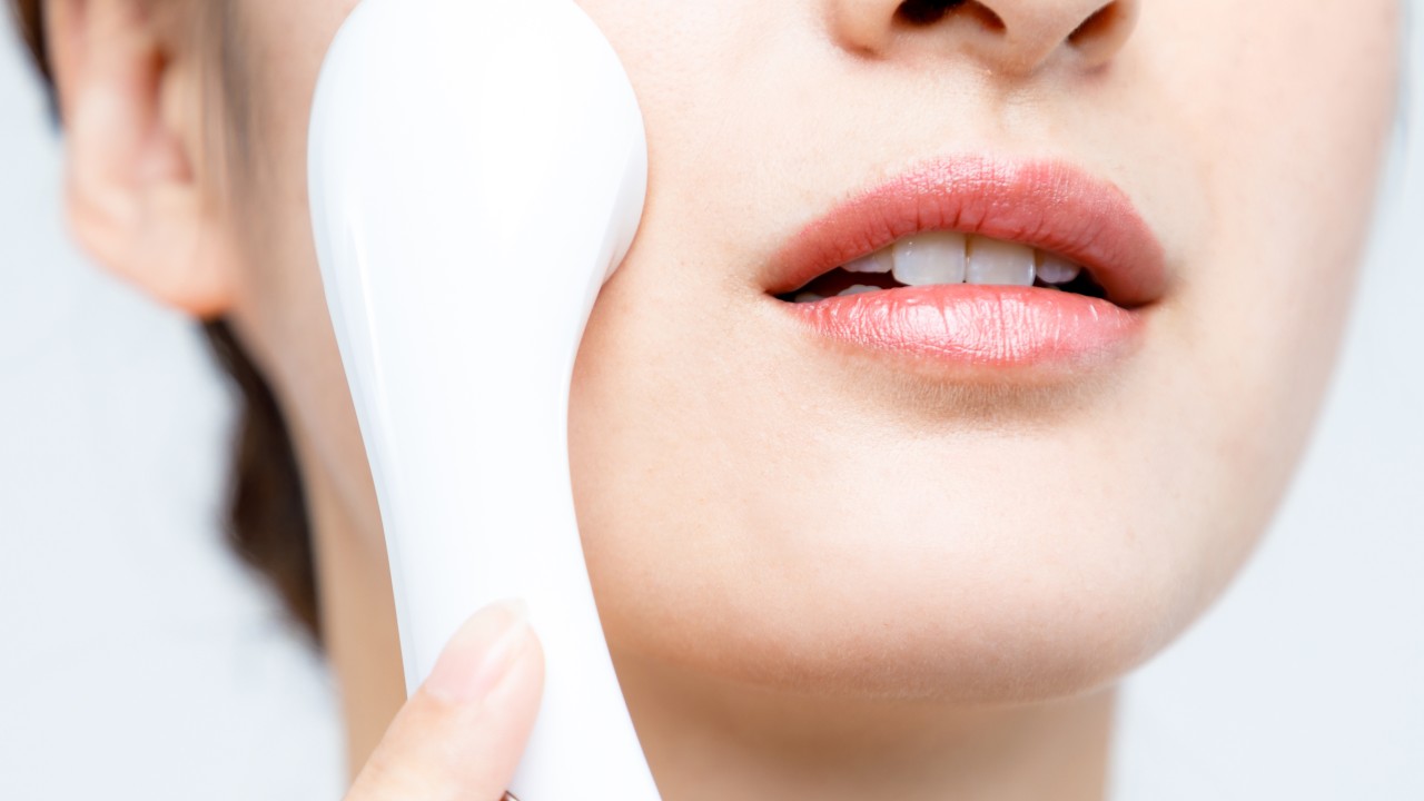 a woman using a skincare tool
