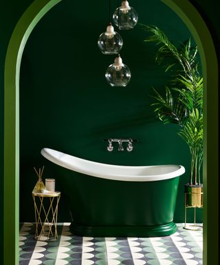 Small green bathtub in a bathroom