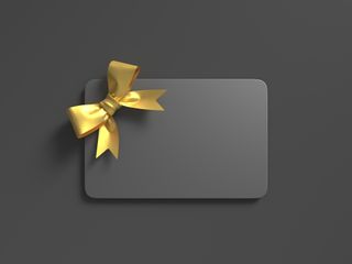 Black Gift Card With Gold Bow - stock photo