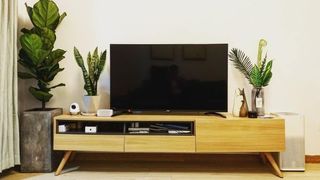 TV on top of a wooden cabinet