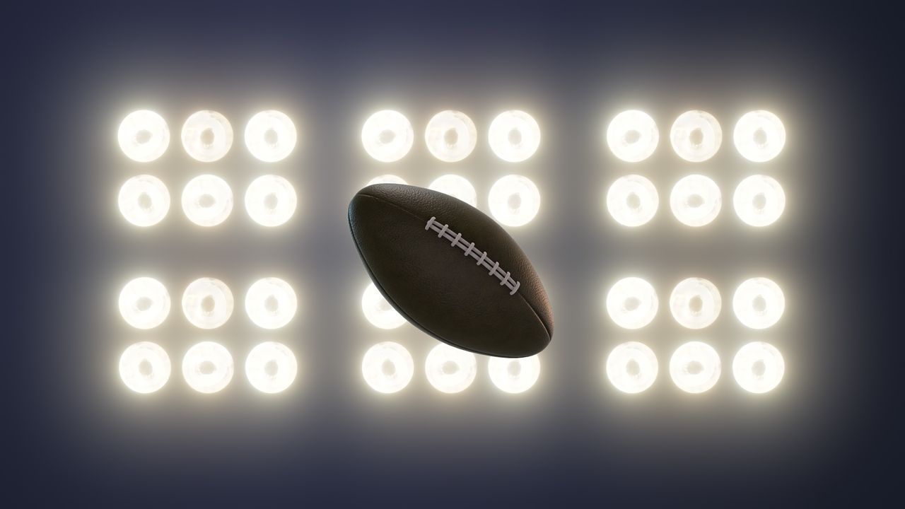 Super bowl football on floodlight background