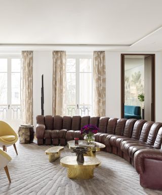 Curved sofa in apartment on Rue du Faubourg Saint-Honoré designed by Le Berre Vevaud. Photo by Stephan Juillaird