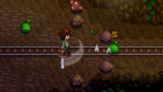 Stardew Valley screenshot - player swinging a sword in a fight against a monster in a mine
