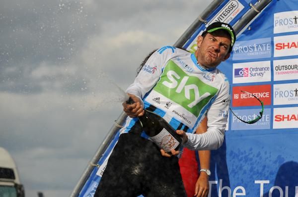 Team Sky's Greg Henderson gives it everything with the champagne.