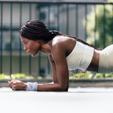 A woman doing a plank outside