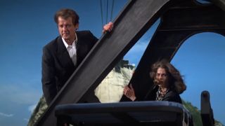 Roger Moore and Lois Chiles climbing onto the top of a cable car in Moonraker.