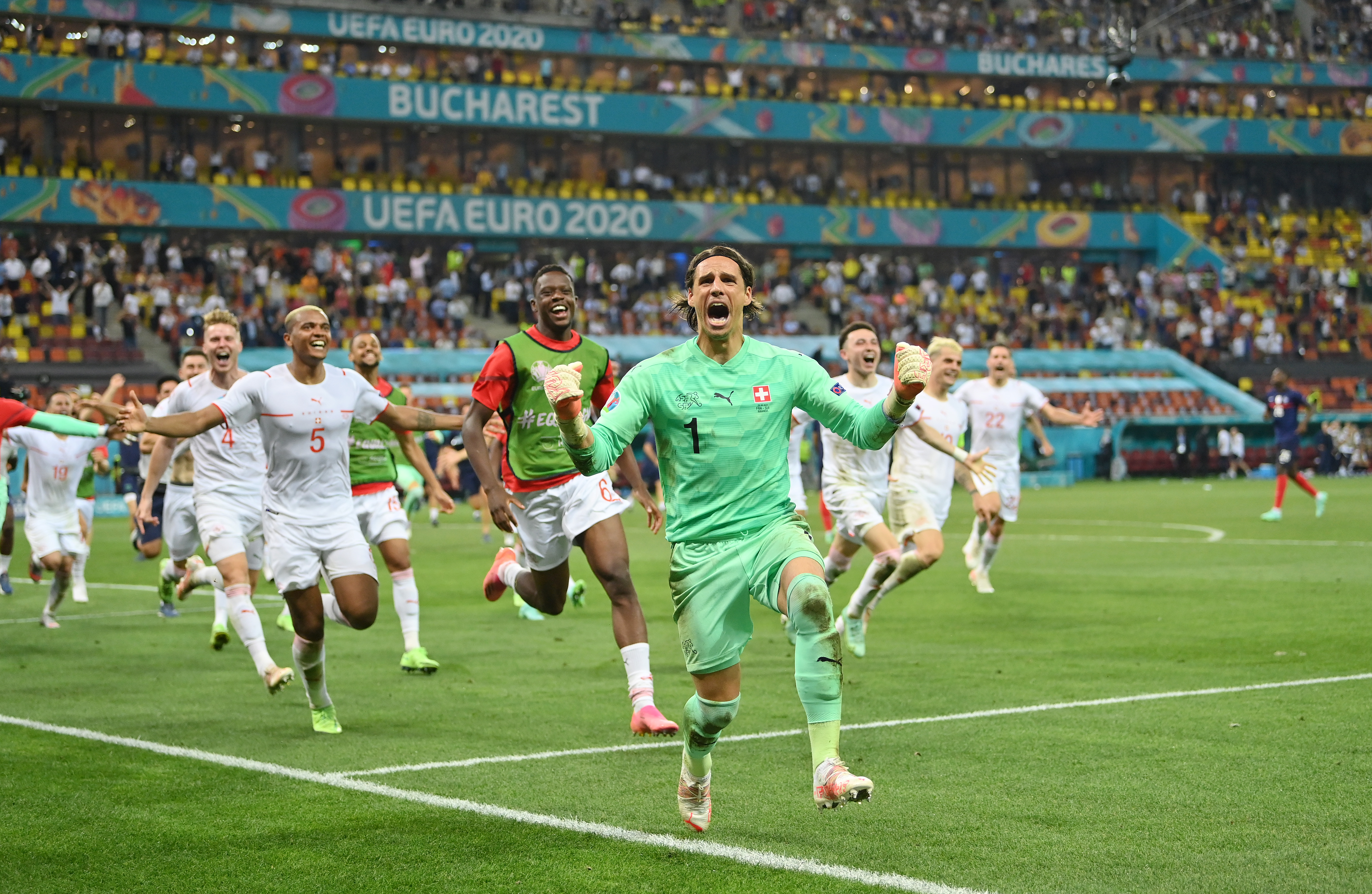 Switzerland goalkeeper Yann Sommer and his team-mates celebrate after their win over France on penalties at Euro 2020.