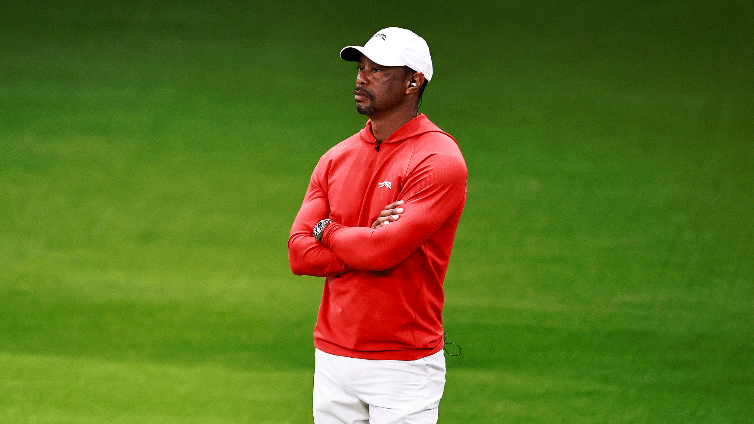 Tiger Woods stands with his arms crossed during the TGL semi-finals in 2026