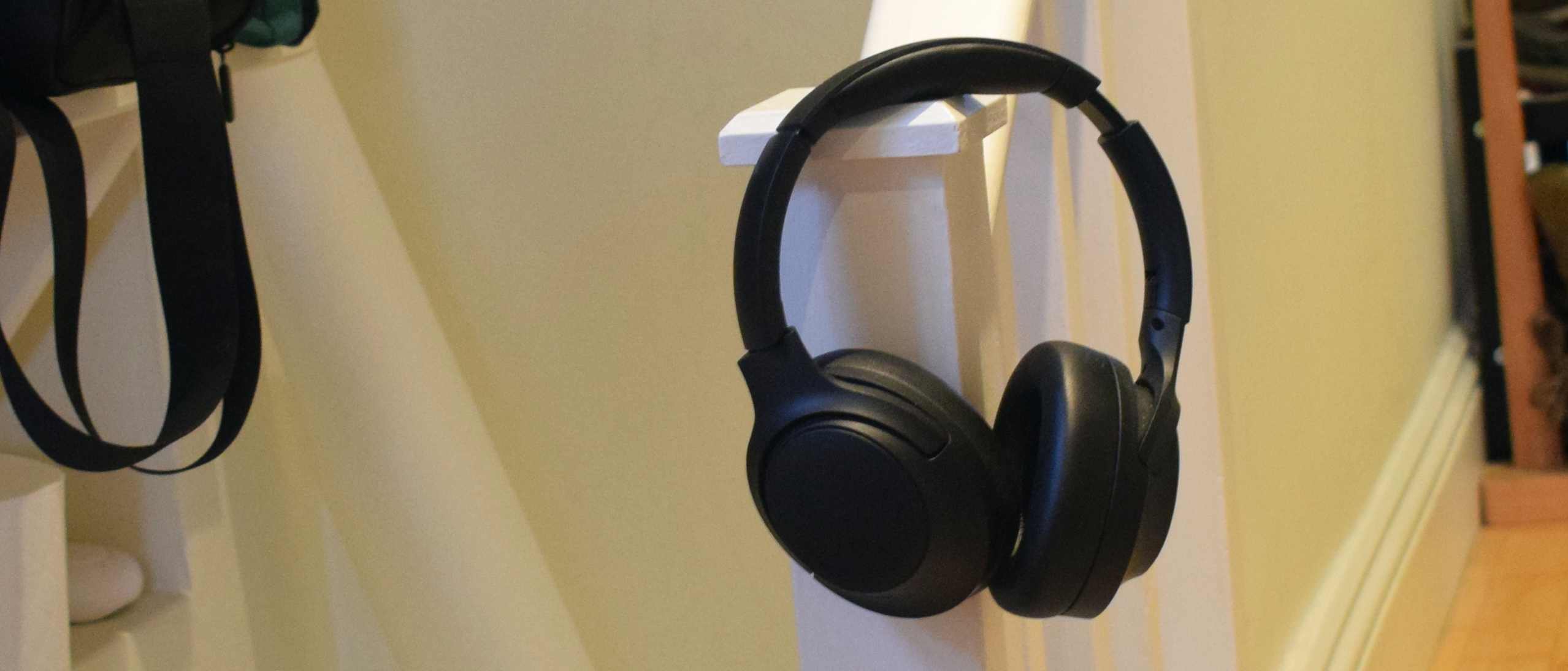 The Soundpeats Cove Pro hanging on a banister.