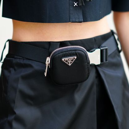 A small black Prada fanny pack