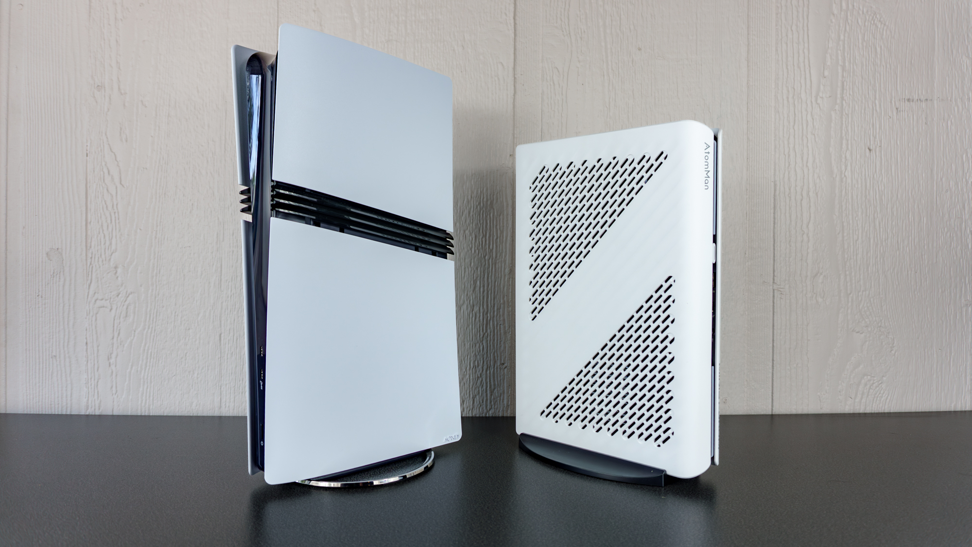 The Minisforum G1 Pro next to a PS5 Pro on a table