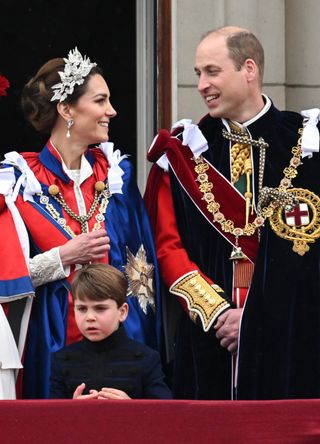 Prince William and Kate Middleton (with Prince Louis) on the balcony of Buckingham Palace during the Coronation of King Charles