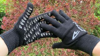 Black cycling gloves on hands