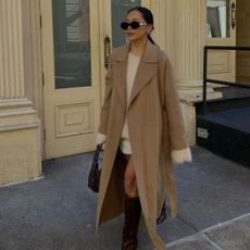 An image of @dawn.tan wearing one of the best camel coats. 